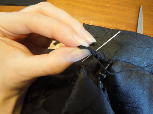 Unpick a bit of the skirt waistband, shove the ends of the zip in and sew over neatly into a squared off end
